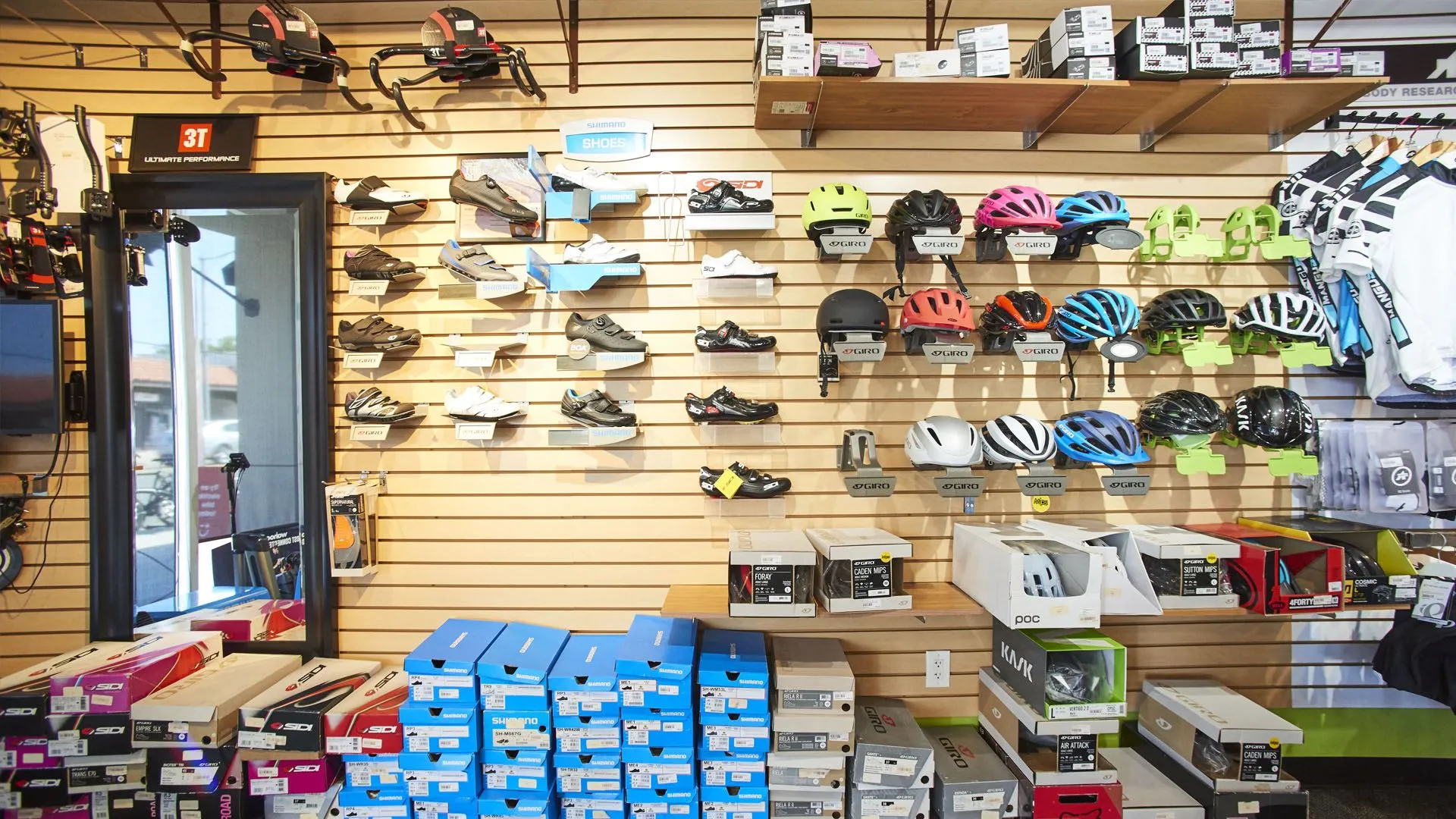 Wall of cycling shoes and helmets